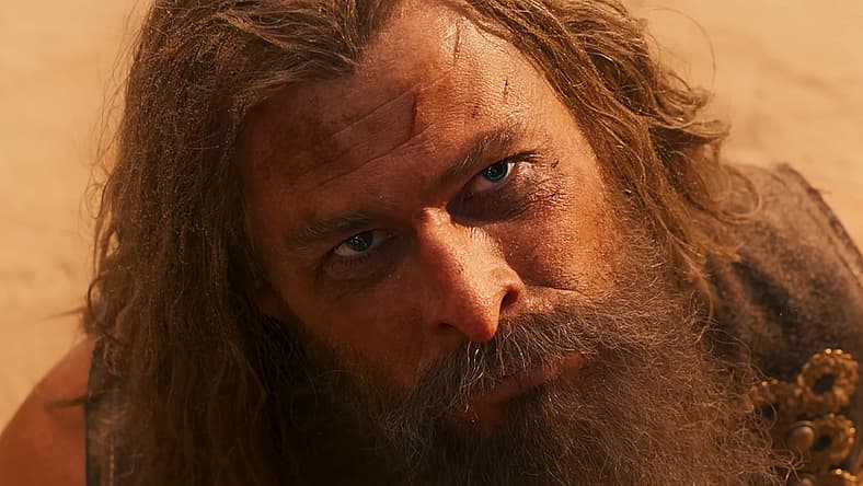Warlord Dementus (Chris Hemsworth) at mercy of Furiosa (Anya Taylor-Joy) in Furiosa: A Mad Max Saga