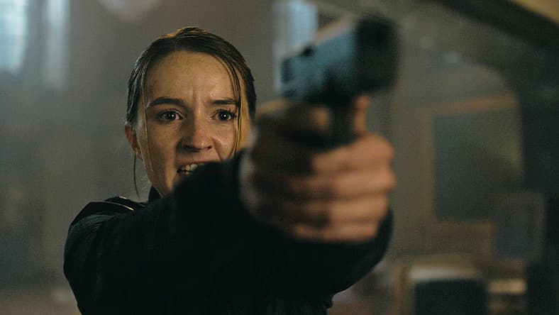 Abby (Kaitlyn Dever) puts Ellie (Bella Ramsey) in her sights in The Last of Us Season 2 Episode 7