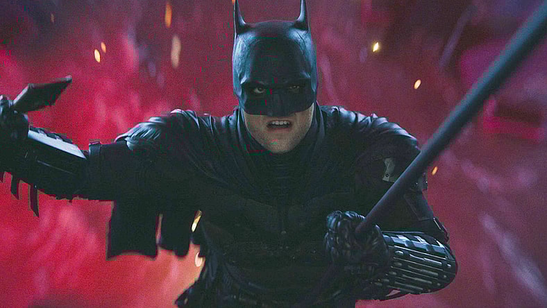 Batman (Robert Pattinson) narrowly escapes The Riddler's (Paul Dano) attempt to drown him in The Batman (2022), Warner Bros. Pictures