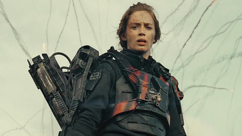 The Angel of Verdun (Emily Blunt) looks on as Major William Cage (Tom Cruise) embarrasses himself on the battlefield in Edge of Tomorrow (2014), Warner Bros. Pictures via Blu-ray