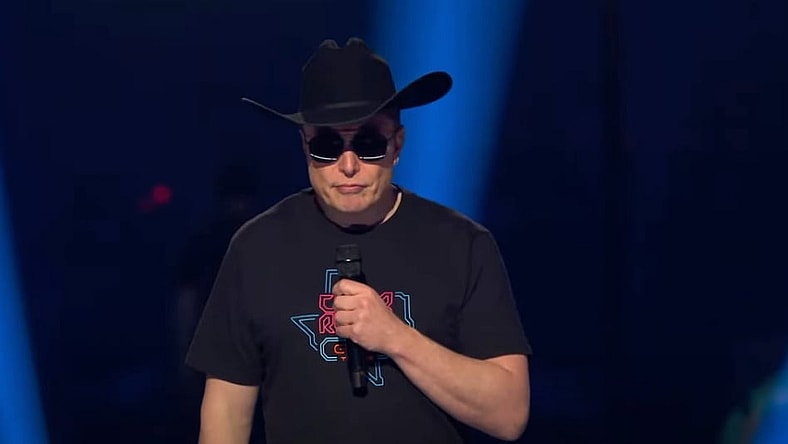 Elon Musk in hat at Tesla