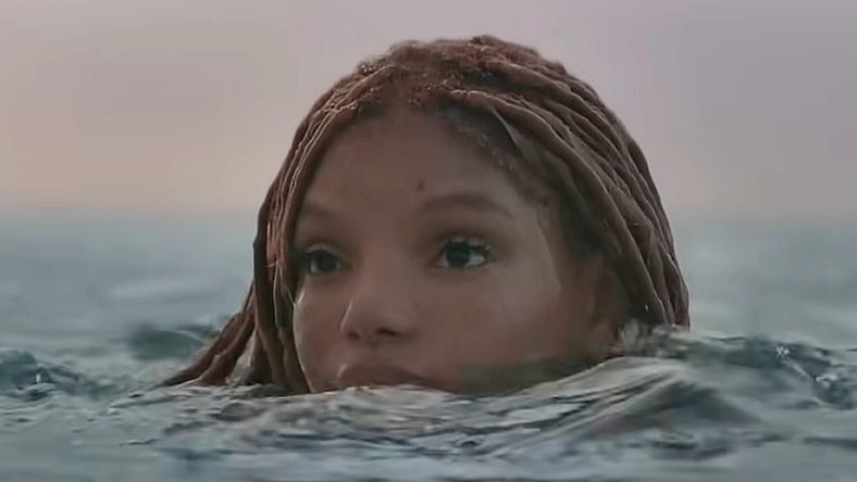 Ariel (Halle Bailey) pops her head above the ocean's surface in The Little Mermaid (2023), Disney