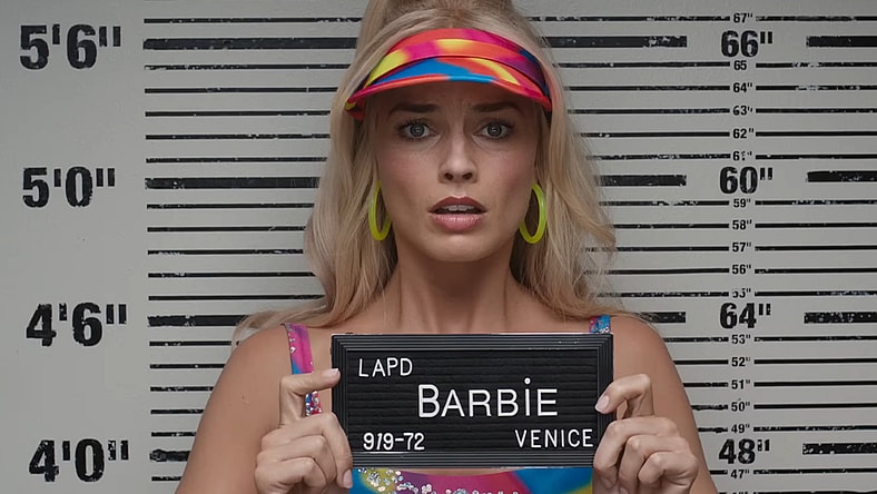 Barbie (Margot Robbie) is arrested in Los Angeles n in Barbie (2023), Warner Bros. Pictures
