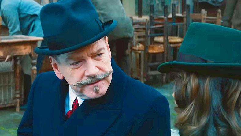 Hercule Poirot (Kenneth Branagh) is intrigued by Ariadne Oliver's (Tina Fey) story in A Haunting in Venice (2023), 20th Century Studios
