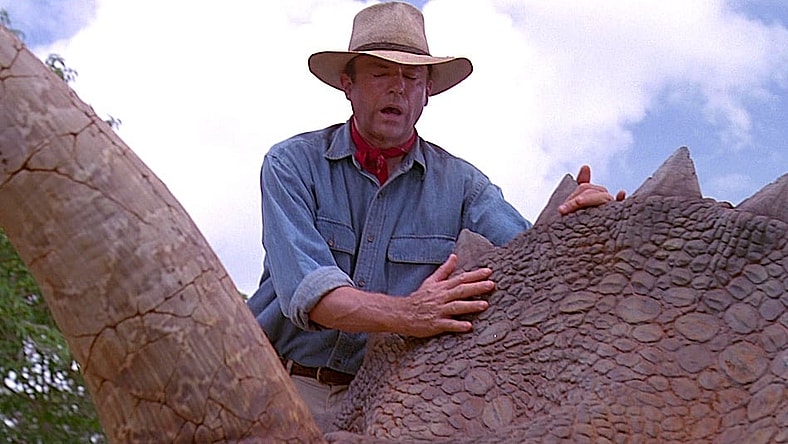 Dr. Alan Grant (Sam Neil) feels the skin of a dinosaur for the first time in Jurassic Park (1993), Universal Pictures
