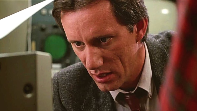 Max Renn (James Woods) has his head buried in media in Videodrome (1983), Universal Pictures