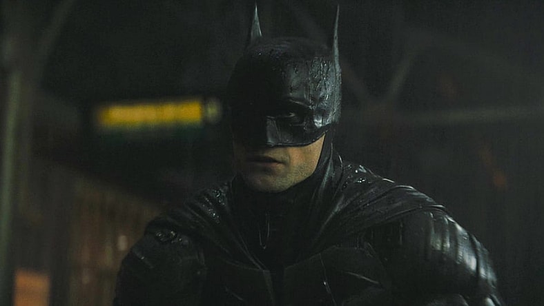 Batman (Robert Pattinson) reveals himself to a gang attempting a robbery in The Batman (2022), Warner Bros. Pictures