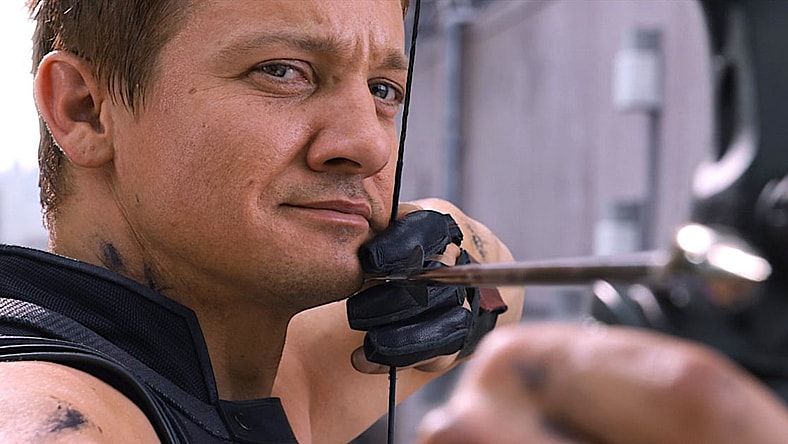 Hawkeye (Jeremy Renner) has his eyes on Loki (Tom Hiddleston) in The Avengers (2012), Marvel Studios