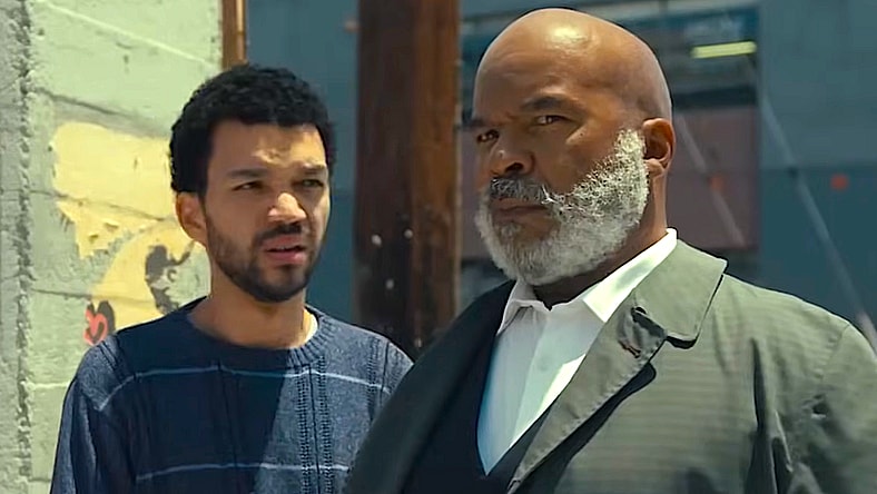 Justice Smith as Aren and David Alan Grier as Roger in The American Society of Magical Negroes (2024), Focus Features