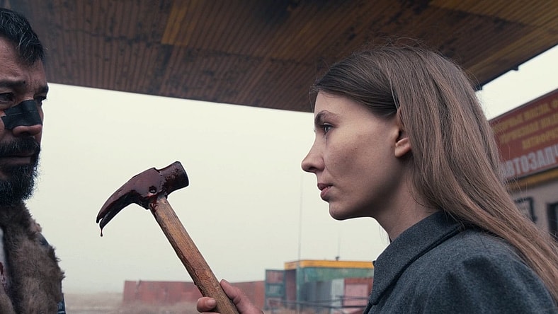 (From L to R) Berik Aizhanov and Anna Starchenko as Brajyuk and Tamara in the action thriller Steppenwolf (2024), Blue Finch Film Releasing