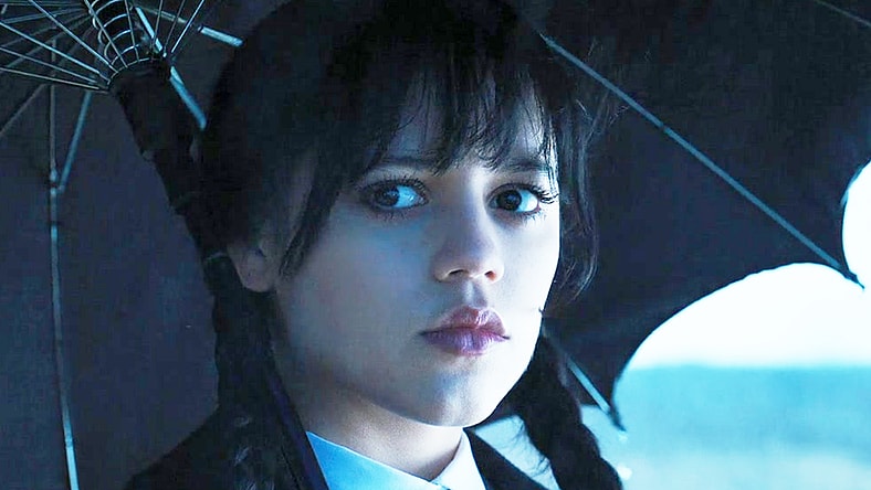 Wednesday (Jenna Ortega) notices something amiss at Mayor Walker's (Tommie Earl Jenkins) funeral in Wednesday Season 1 Episode 7 "If You Don't Woe Me by Now" (2022), Netflix