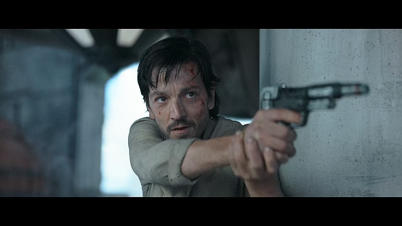 Cassian Andor (Diego Luna) saves Jyn Erso (Felicity Jones) from an early death at the hands of Director Krennic (James Luceno) in Rogue One: A Star Wars Story (2016), Lucasfilm