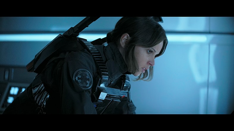 Jyn Erso (Felicity Jones) scours the Imperial databases for the plans to the Death Star in Rogue One: A Star Wars Story (2016), Lucasfilm