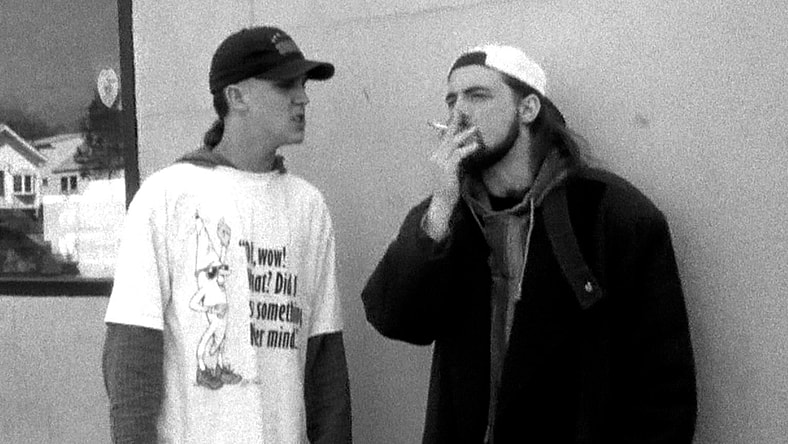 Jay (Jason Mewes) and Silent Bob (Kevin Smith) post up outside of the Quick Stop in Clerks (1994), View Askew Productions