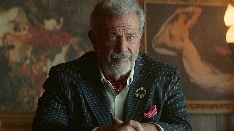 Cormac (Mel Gibson) interrogates Winston (Colin Woodell) for information regarding Frankie's (Ben Robson) location in The Continental: From the World of John Wick Episode 1 "Brothers in Arms" (2023), Lionsgate Television