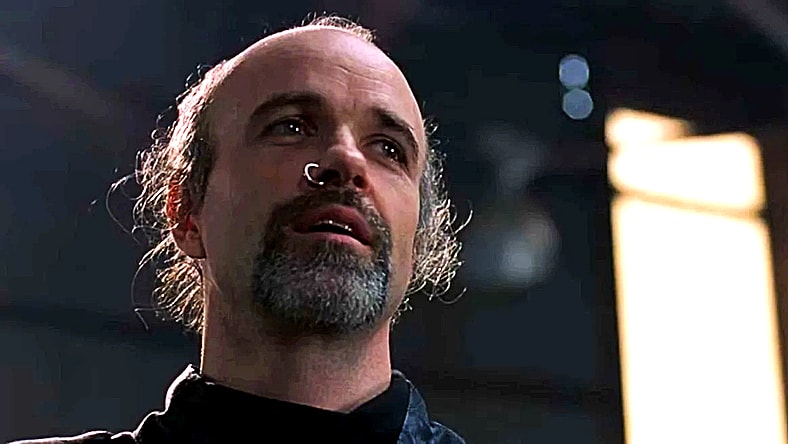 Despite the attempt on his life, Cain (Tom Noonan) forgives an offscreen Alex Murphy (Peter Weller) in RoboCop 2 (1990), Orion Pictures