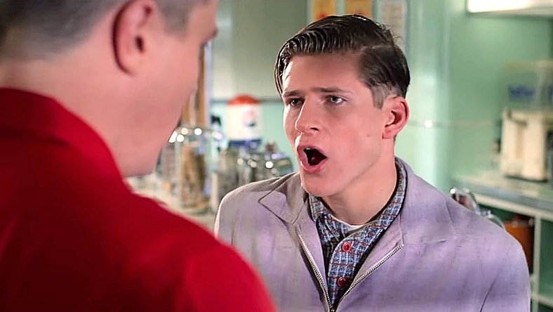 Biff (Thomas F. Wilson) gives George (Crispin Glover) a reminder in Back to the Future (1985), Universal Pictures