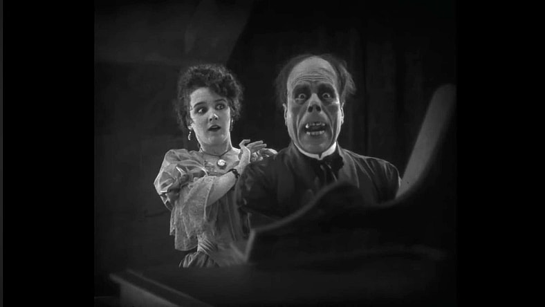 Lon Cheney realizes that catfishing only works for so long in The Phantom of the Opera (1925), Universal Pictures