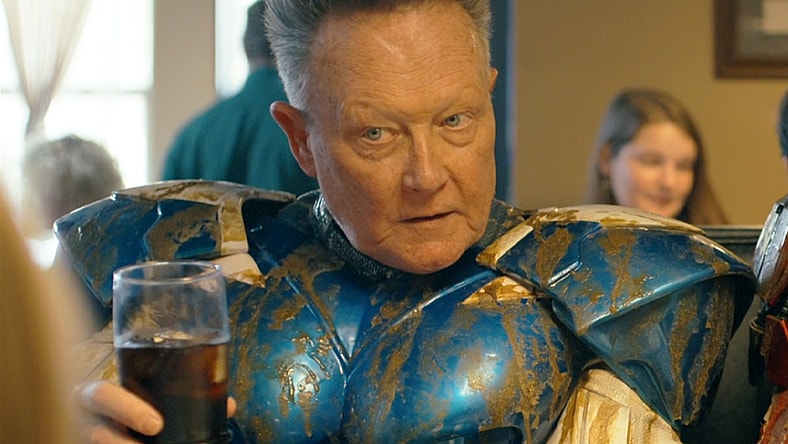 Blue Dragon (Robert Patrick) raises a glass to the Top Trio's latest victory in Peacemaker Season 2 Episode 6 "Ignorance is Chris" (2025), DC Studios