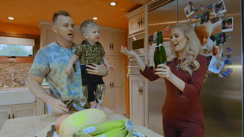 Spencer Pratt, carrying his son Gunner while his wife Heldi Montag opens a wine bottle in The Hills: New Beginnings Season 1, 2019, MTV