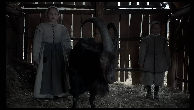 Mercy (Ellie Grainger), Jonas (Lucas Dawson), and Black Phillip (Charlie) in The VVitch (2015), A24