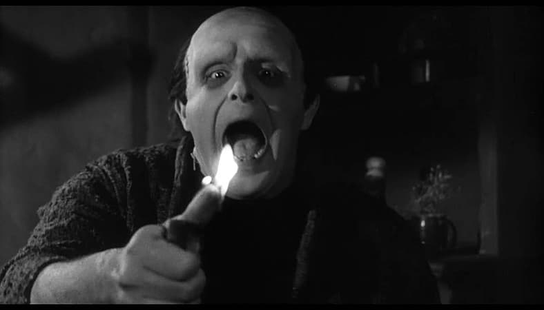 The Monster (Peter Boyle) smokes a cigar in Young Frankenstein (1974), 20th Century Fox