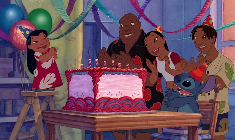Cobra Bubbles (Ving Rhames), Nani (Tia Carrere), Stitch (Chris Sanders), and David Jason Scott Lee) celebrate Lilo's (Daveigh Chase) birthday in Lilo & Stitch (2002), Walt Disney Studios