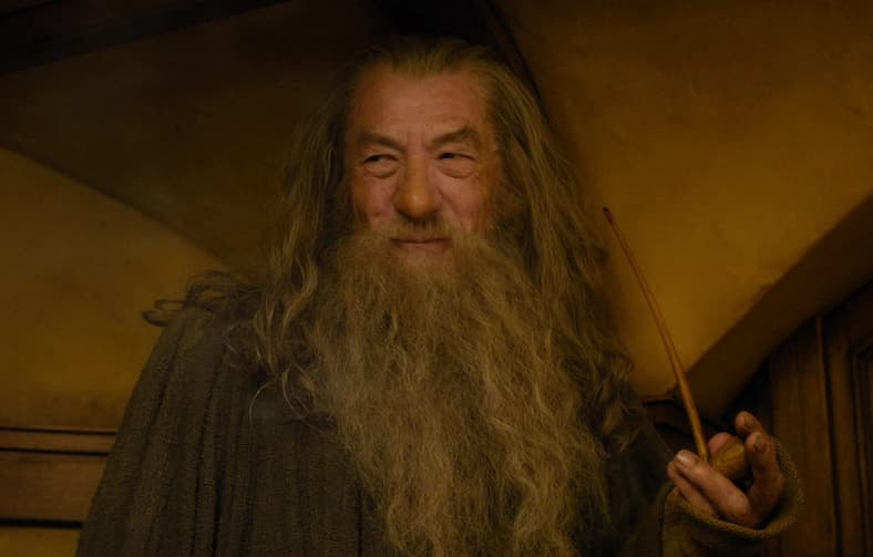 Gandalf (Sir Ian McKellen) attends Dwarven dinner with Bilbo Baggins (Martin Freeman) in The