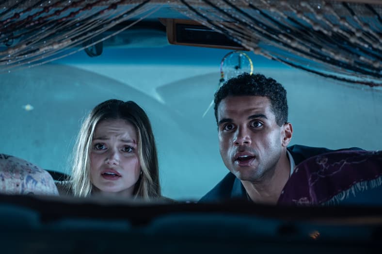 Ally (Olivia Holt) and Jay (Mason Gooding) hiding from the Heart Eyes Killer in Heart Eyes (2025), Screen Gems