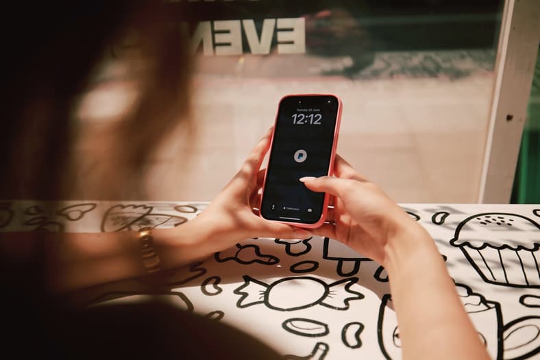 A woman uses PayPal on her phone via PayPal