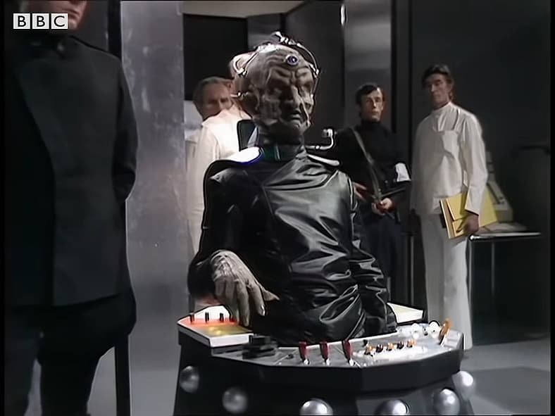 Davros (Michael Wisher) introduces himself to The Doctor (Tom Baker) in Genesis of the Daleks