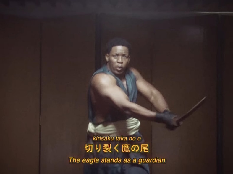 Yasuke (Ruan “jogazulu” Silva) studies the blade in the live-action tokusatsu commercial for Assassin's Creed Shadows (2025), Ubisoft