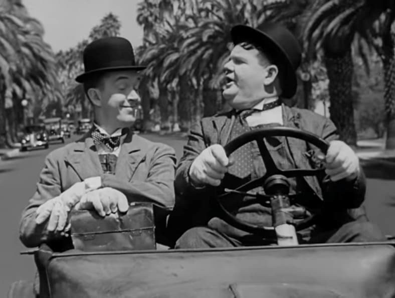 Stan Laurel and Oliver Hardy drive to their new job in Laurel and Hardy in "Busy Bodies" (1933), MGM