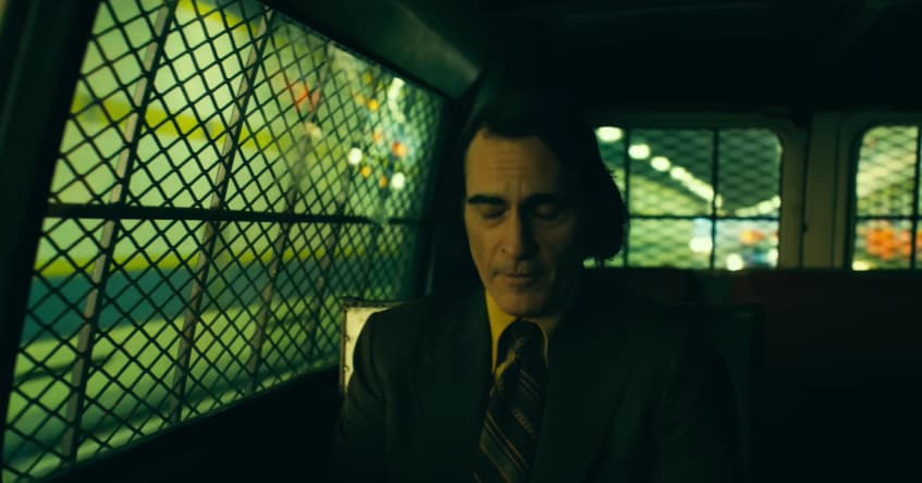 Arthur (Joaquin Phoenix) tries to calm his nerves in Joker: Folie à Deux (2024), Warner Bros. Pictures
