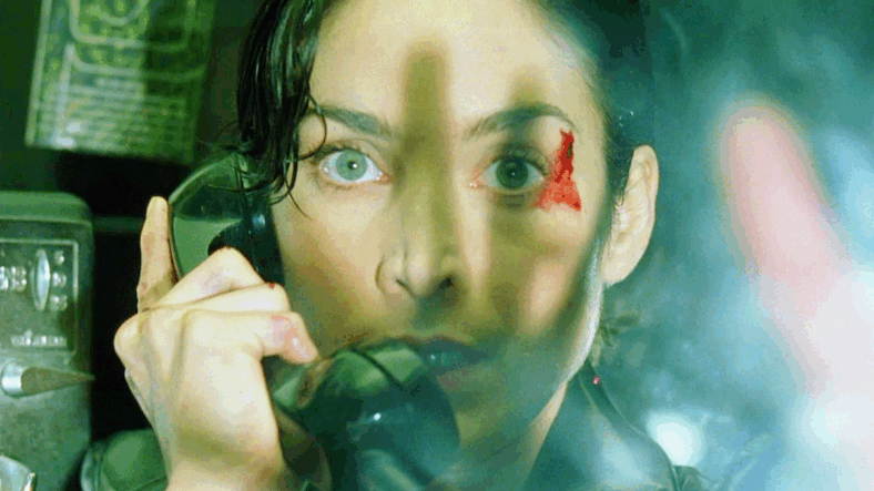 Trinity (Carrie-Ann Moss) requests immediate extraction in The Matrix (1999), Warner Bros. Pictures