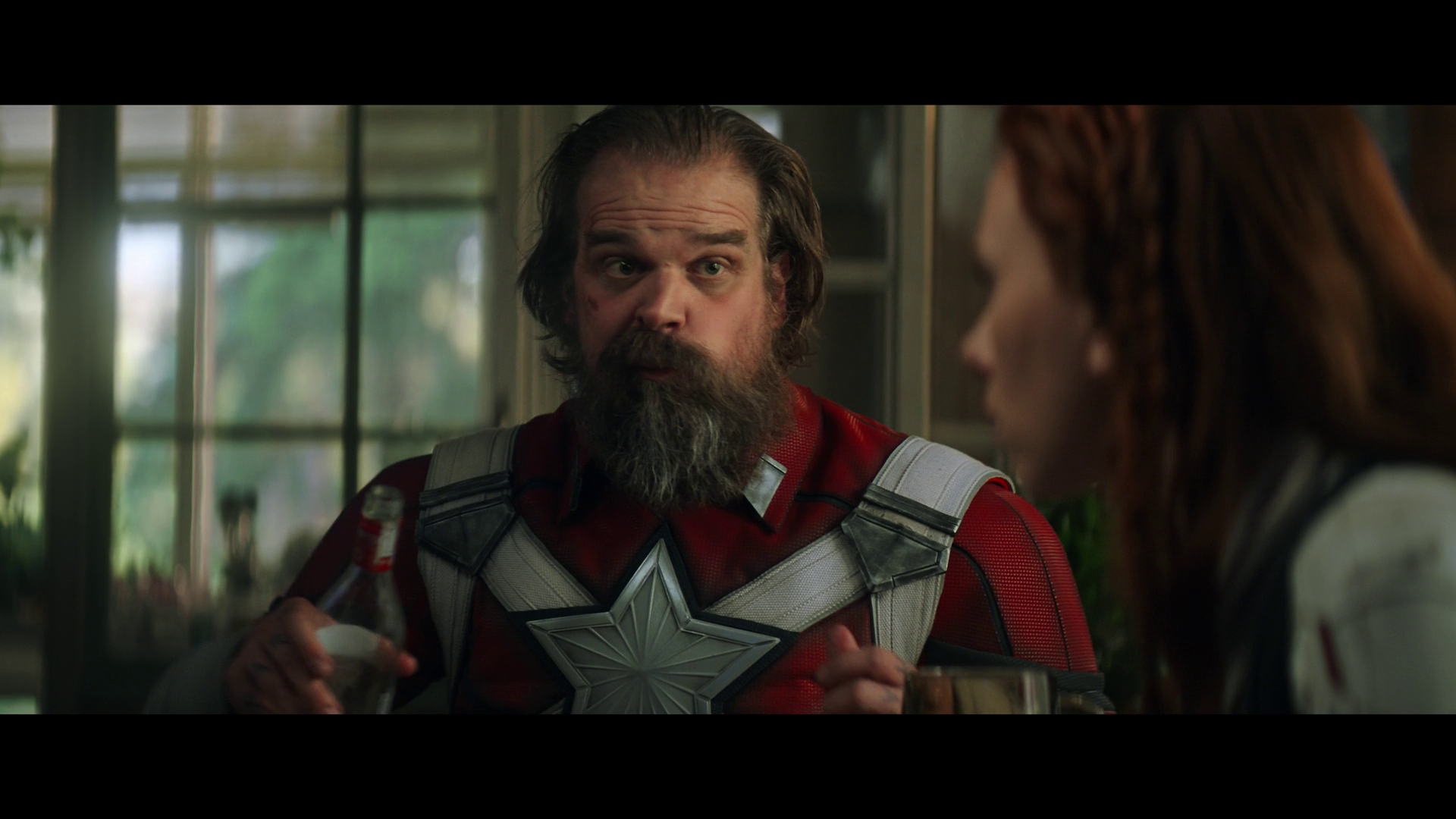 Red Guardian (David Harbour) shares a meal with Natasha (Scarlett Johansson) in Black Widow (2021), Marvel Entertainment