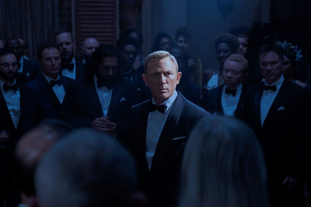 James Bond (Daniel Craig) realizes he's walked into a SPECTRE trap in No Time to Die (2021), MGM