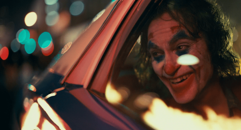 Arthur (Joaquin Phoenix) goes for a ride in Joker (2019), Warner Bros. Pictures