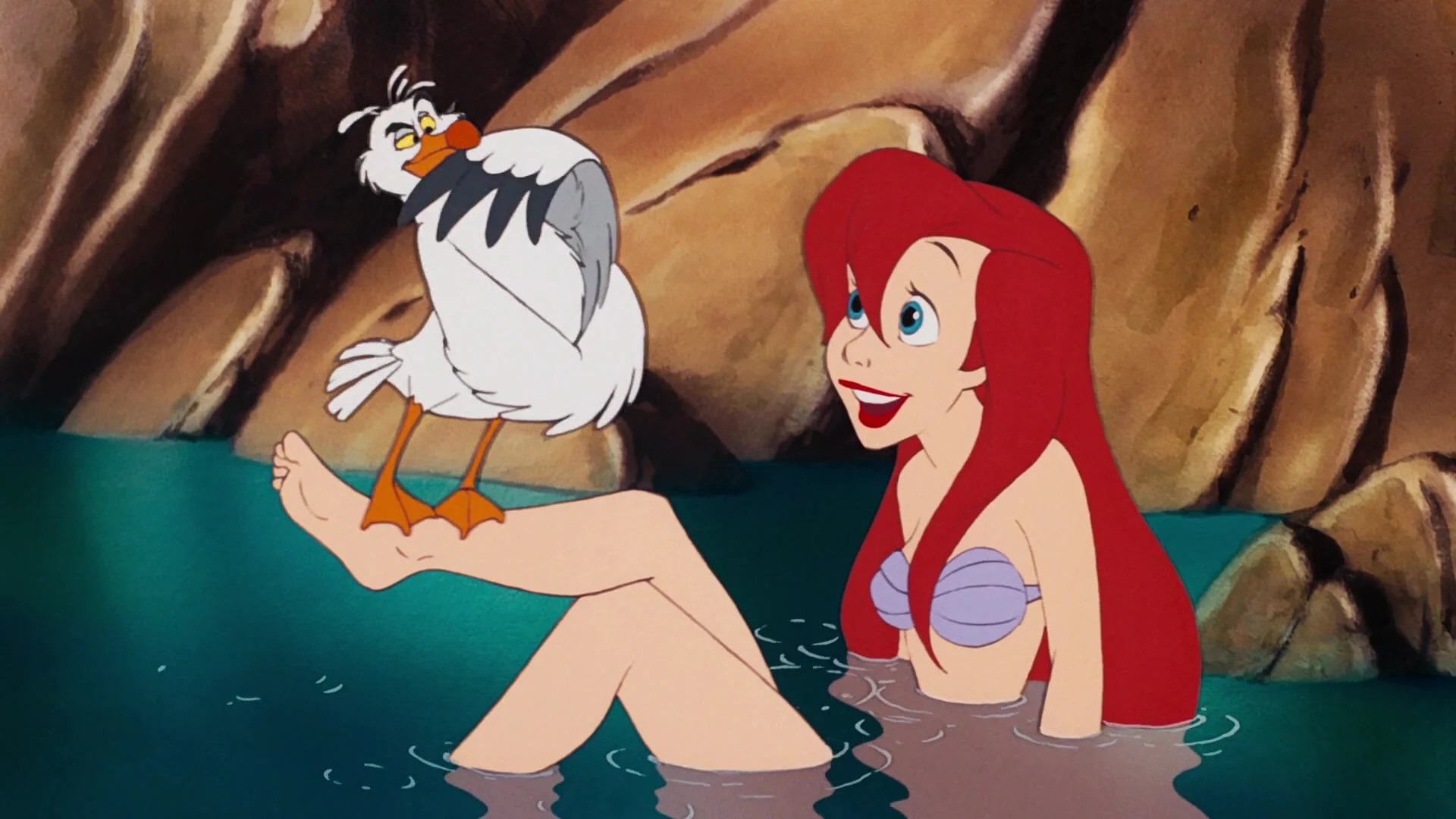 Ariel (Jodi Benson) shows off her new legs to Scuttle (Buddy Hackett) in The Little Mermaid (1989), Disney