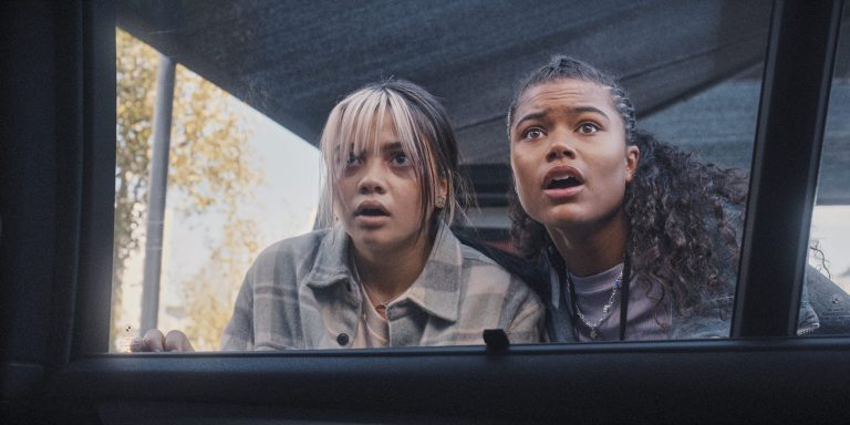 Billie (Siena Agudong) and Jade Wesker (Tamara Smart) attempt to sneak past an Umbrella security unit in Resident Evil Season 1 Episode 2 "The Devil You Know" (2022), Netflix 