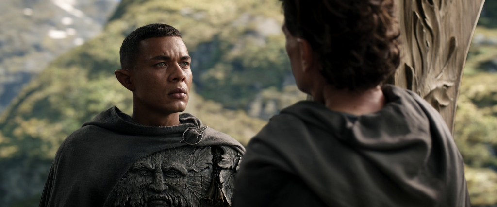 Arondir (Ismael Cruz Cordova) speaks with Médhor (Augustus Prew) in The Lord of the Rings: The Rings of Power Season 1 Episode 1 "A Shadow of the Past" (2022), Amazon Studios.