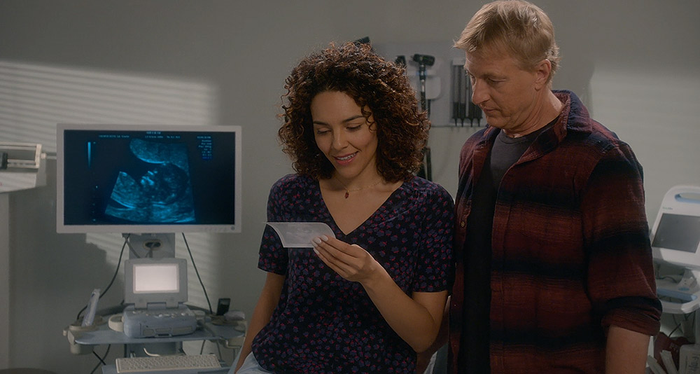 Carmen and Johnny look at a sonogram of their baby in Cobra Kai, season 5