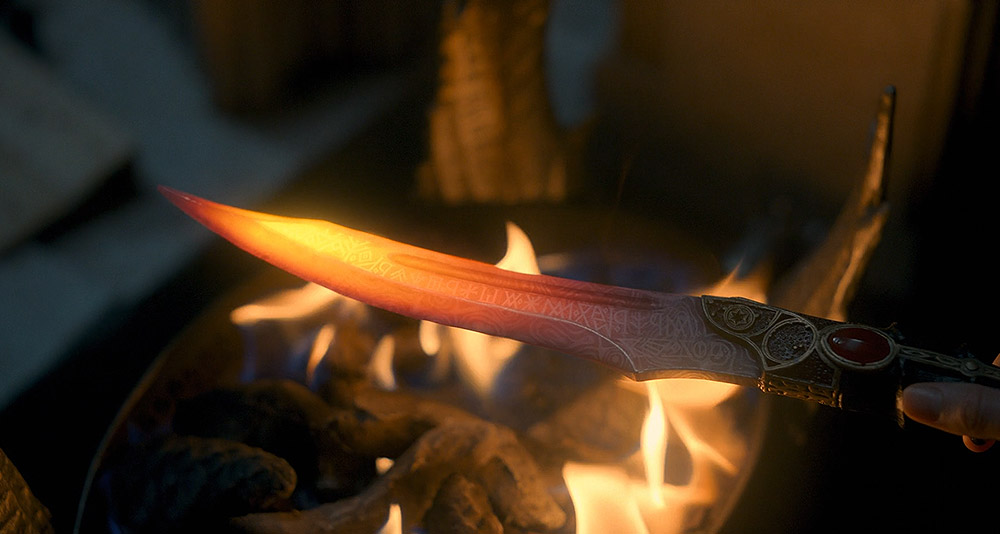 Rhaenyra reads an inscription on an ancient blade in House of the Dragon, HBO