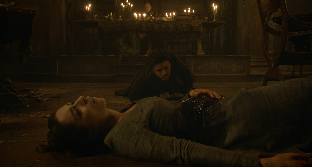 Robb Stark crawls to a murdered Talisa during the Red Wedding in Game of Thrones, HBO