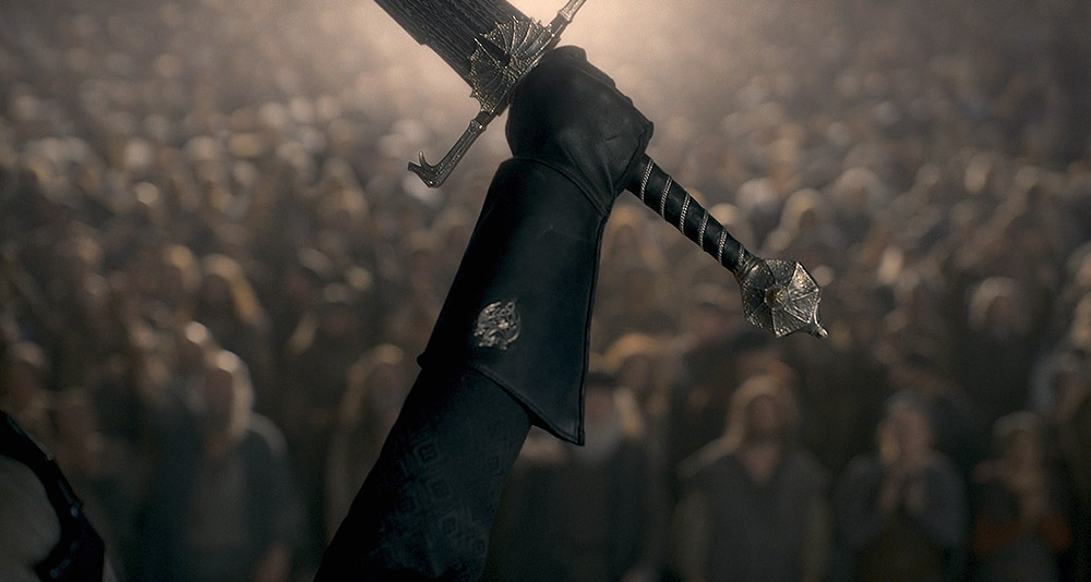 Aegon holding a sword aloft in House of the Dragon, HBO