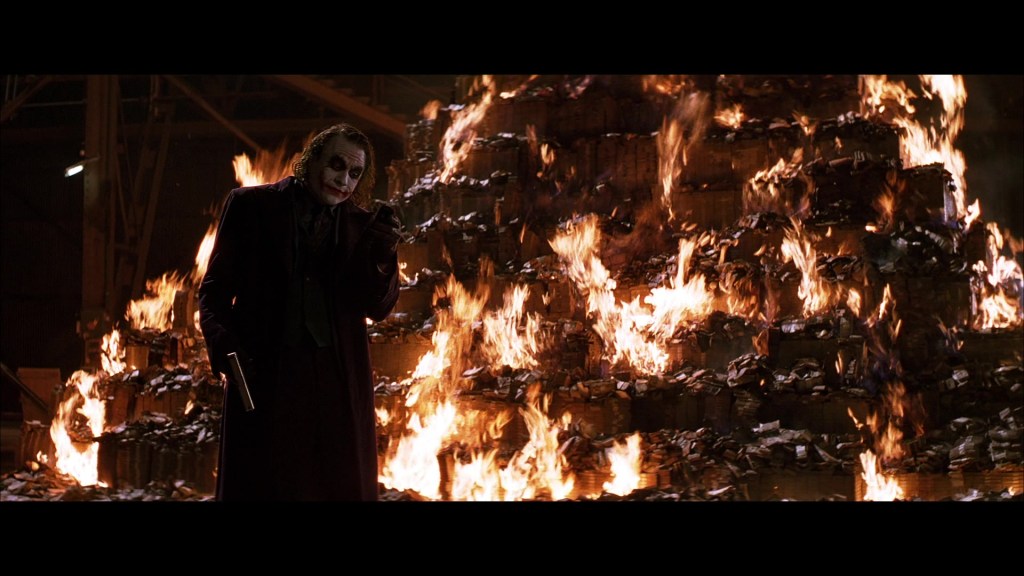 Joker (Heath Ledger) burns his cut in The Dark Knight (2008), Warner Bros. Pictures