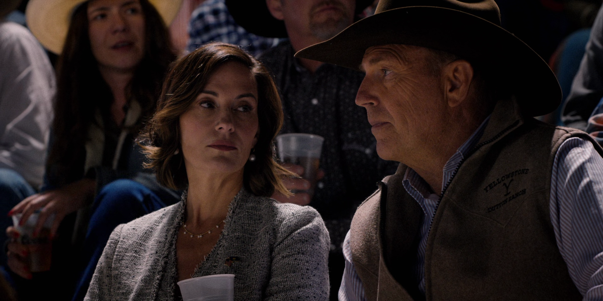 Beth Dutton (Kelly Reilly) talks with her husband John (Kevin Costner) during the local rodeo via Yellowstone Season 3 Episode 3 "An Acceptable Surrender" (2020), Paramount