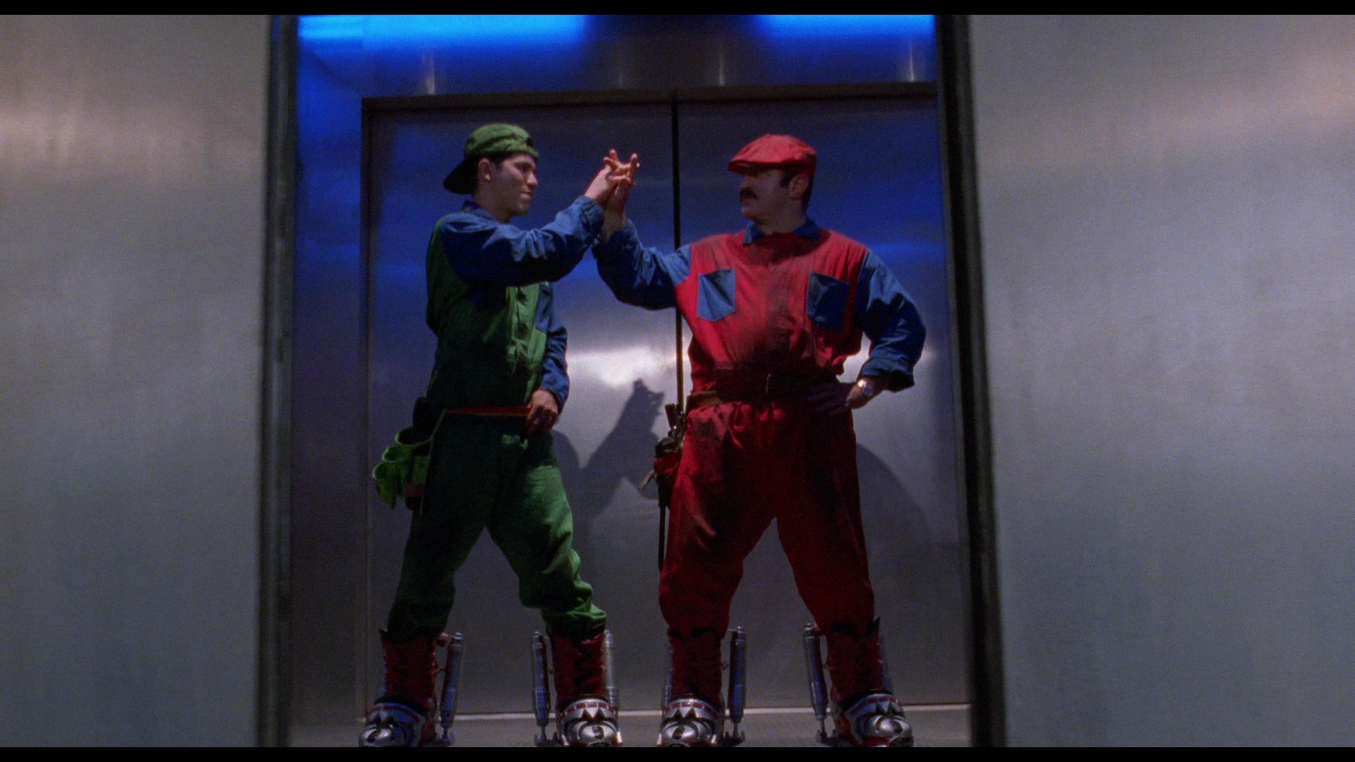 Mario (Bob Hoskins) and Luigi (John Leguizamo) don their signature attire in Super Mario Bros. (1993), Walt Disney Studios via Blu-ray