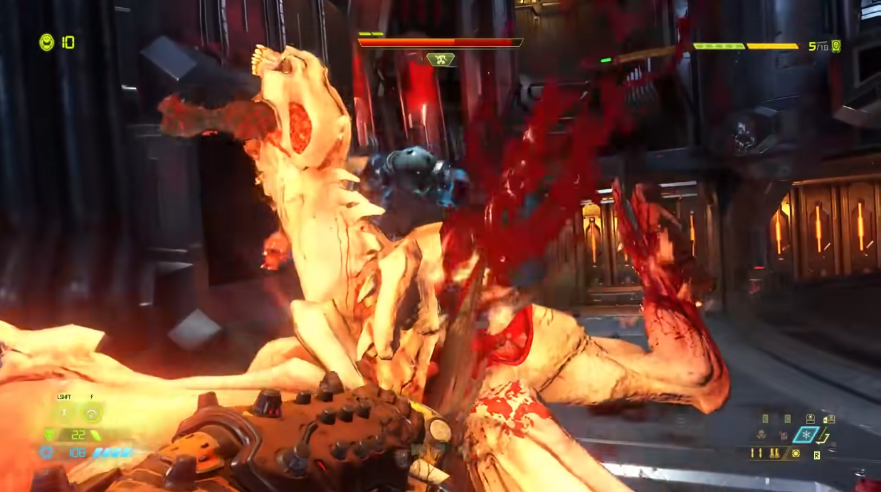 The Doomslayer cuts through the burning carcass of a Doom Hunter via Doom Eternal (2020), Bethesda Softworks