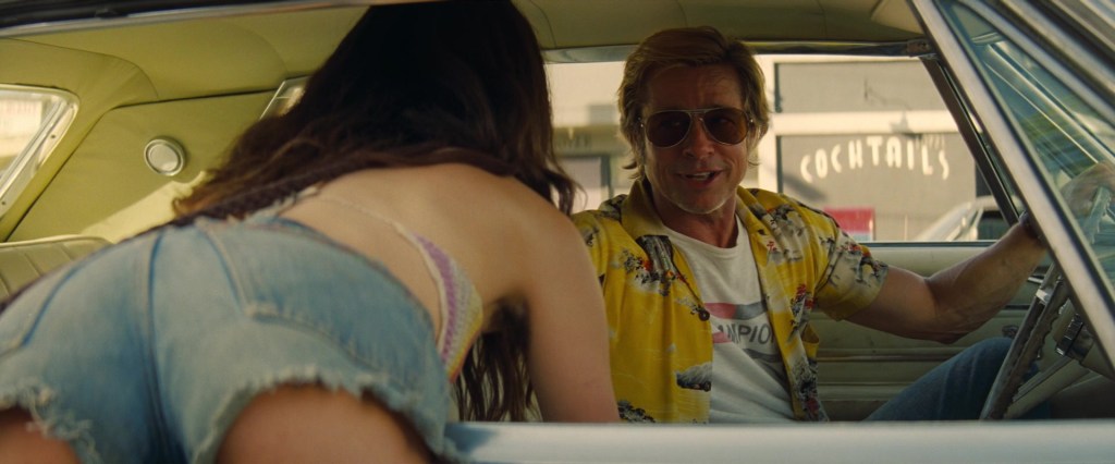 'Pussycat' (Margaret Qualley) asks Cliff Booth (Brad Pitt) for a ride in Once Upon A Time In Hollywood (2019), Sony Pictures